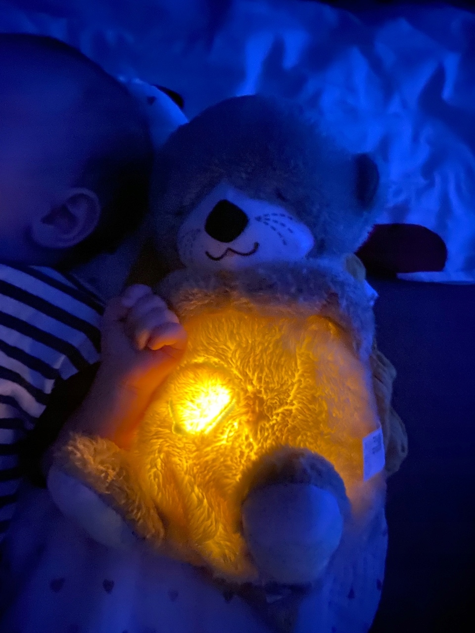 LulliMiś świecący w nocy, dziecko trzyma go podczas snu